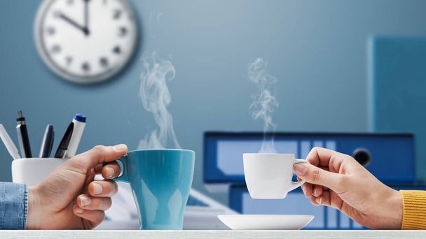 Office workers taking a break during work hours, they are drinking coffee together - 写真・画像