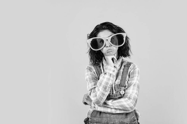 making funny faces. girl with copy space. feel happiness and joy. funny beautiful lady in denim style with party glasses. party fun time. female in sunglasses. cheerful woman event manager. - 写真・画像