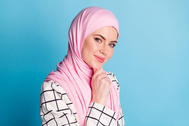 Close-up profile side view portrait of pretty cunning cheery muslimah girl touching chin thinking isolated over bright blue color background. - Fotoğraf, Görsel