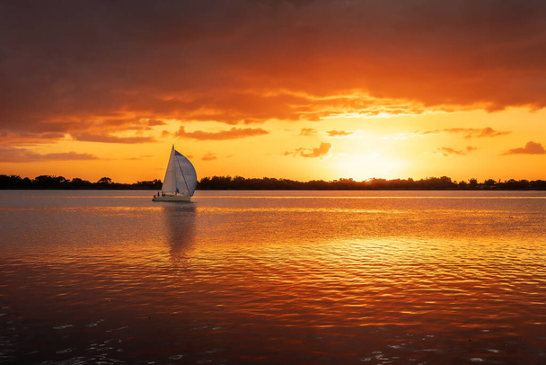 Sunset at Guaiba River with Sail Boat - Porto Alegre, Rio Grande do Sul, Brazil - Photo, Image