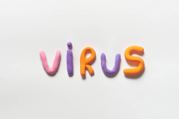 Virus word formed of vivid plasticine on white background. - Zdjęcie, obraz