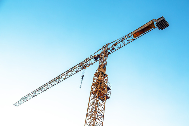 Industrial crane against blue sky - Foto, Imagen