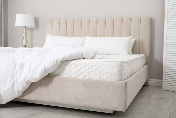 Comfortable bed with soft white mattress, blanket and pillows indoors - Foto, imagen