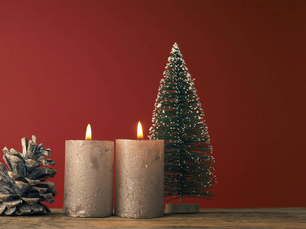 Two Advent candles burning on a red background with Christmas decoration - Photo, image