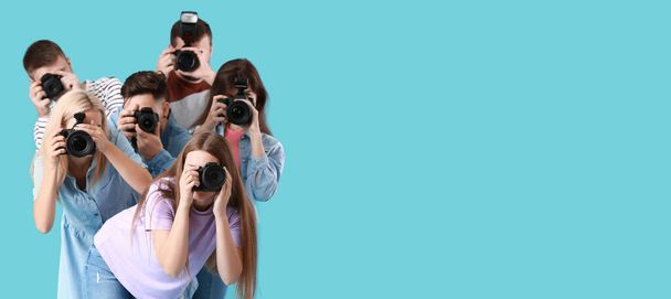 Group of young photographers on blue background - Photo, Image