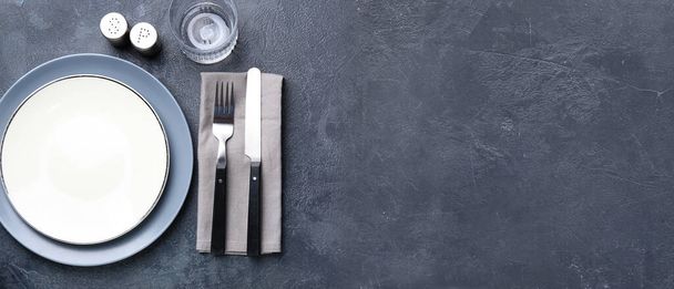 Simple table setting on grey background with space for text - Photo, Image