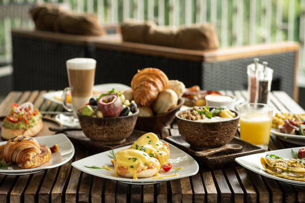 many mixed western breakfast food items on cafe table - Fotó, kép