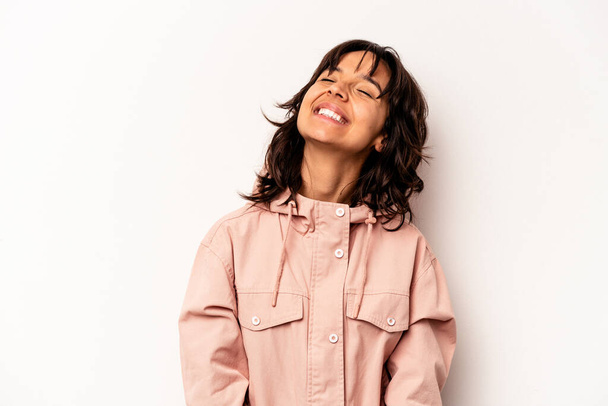 Young hispanic woman isolated on white background relaxed and happy laughing, neck stretched showing teeth. - 写真・画像