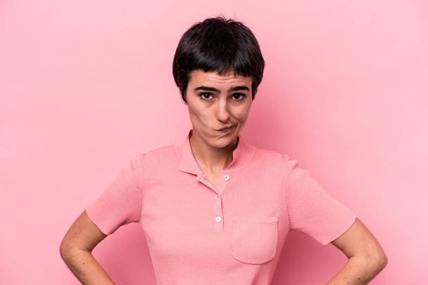 Young caucasian woman isolated on pink background confused, feels doubtful and unsure. - Photo, Image
