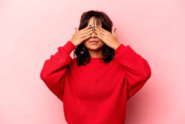 Young hispanic woman isolated on pink background afraid covering eyes with hands. - Φωτογραφία, εικόνα