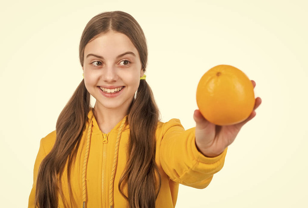 happy teen girl with orange citrus fruit. vitamin and dieting. child eating healthy food. childhood health. selective focus. natural organic fresh grapefruit. healthy life. diet and kid skin beauty. - Fotografie, Obrázek