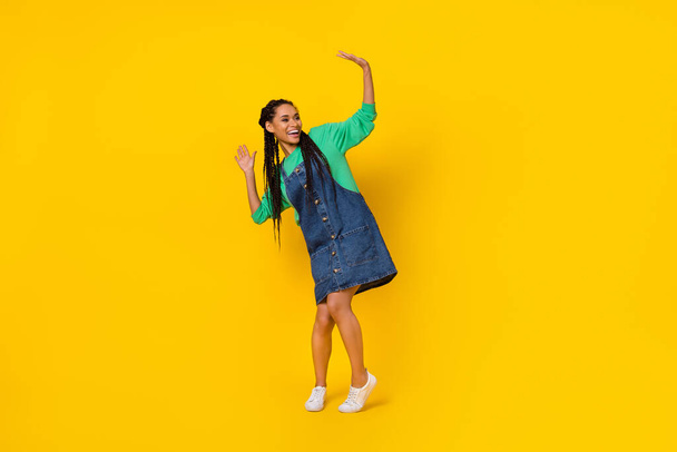 Full size portrait of satisfied cheerful person enjoy partying dancing clubbing isolated on yellow color background. - Fotó, kép