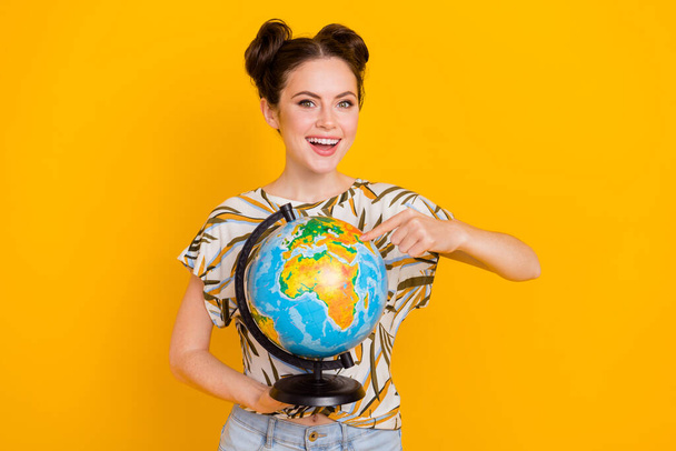 Photo of dreamy excited lady dressed print t-shirt choosing country for next trip isolated yellow color background. - Valokuva, kuva