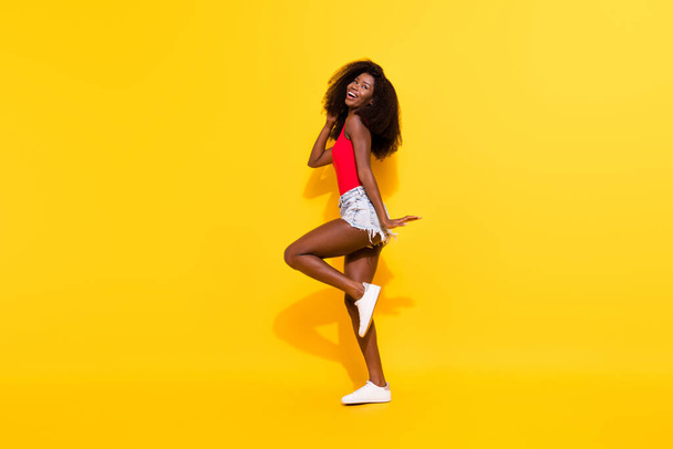 Full length body size photo of overjoyed woman in shorts singlet laughing isolated on bright yellow color background. - Fotoğraf, Görsel