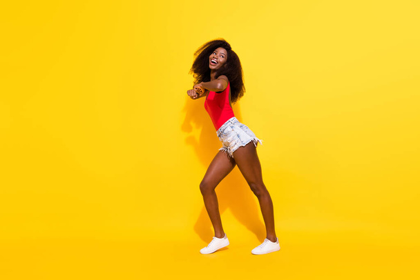 Full length body size view of pretty ecstatic cheerful girl dancing moving having fun isolated over bright yellow color background. - Fotografie, Obrázek
