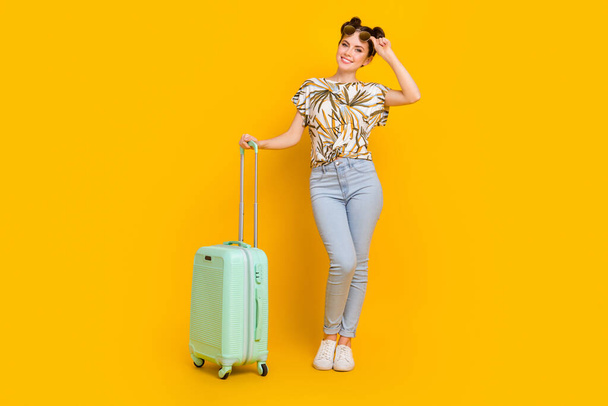 Photo of sweet pretty woman wear print t-shirt arms dark spectacles carrying baggage isolated yellow color background. - Fotoğraf, Görsel