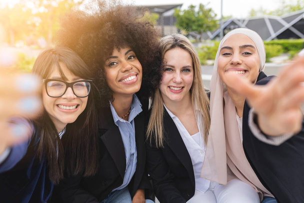 multiracial female business coworkers making their selfie outdoors - 写真・画像