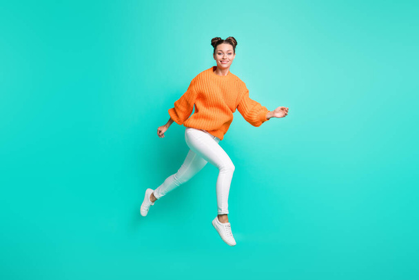 Full size photo of young lovely charming positive girl running in air wear knitted pullover isolated on teal color background. - Foto, Bild