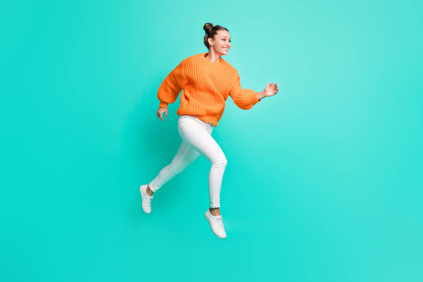 Full size photo of young attractive lovely smiling girl running in air looking copyspace isolated on teal color background. - Foto, Bild