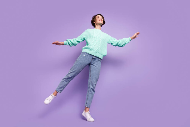 Low angle view photo of pretty graceful girl wearing teal knitted sweater isolated on pastel violet color background. - Foto, afbeelding