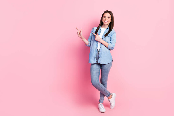 Full size photo of happy nice young woman point finger empty space sale isolated on pastel pink color background. - Fotoğraf, Görsel