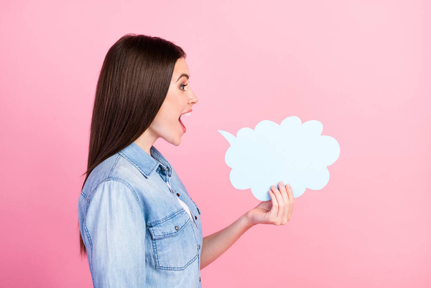 Side profile photo portrait of girl keeping cloud with copyspace telling news isolated on pastel pink color background. - Zdjęcie, obraz