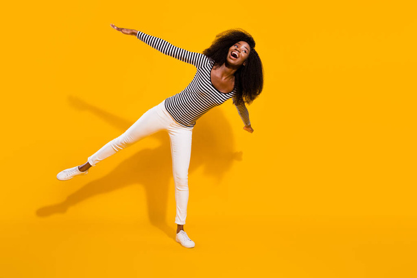 Full length body size photo woman looking empty space pretending plane playful isolated vivid yellow color background. - Valokuva, kuva
