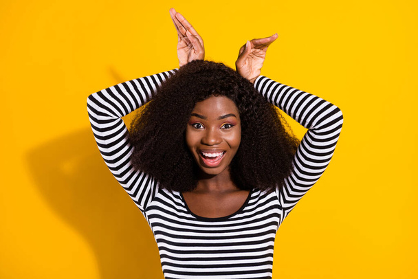 Photo portrait of pretty girl showing bunny ears playful laughing happy isolated on vivid yellow color background. - Zdjęcie, obraz