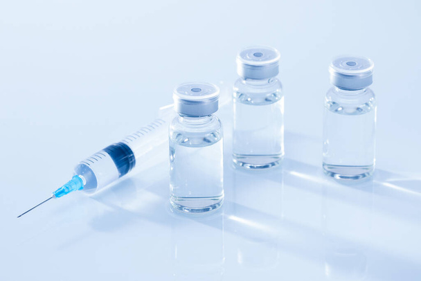 closeup photo of photos of ampoules for injection on white background - Foto, Imagem