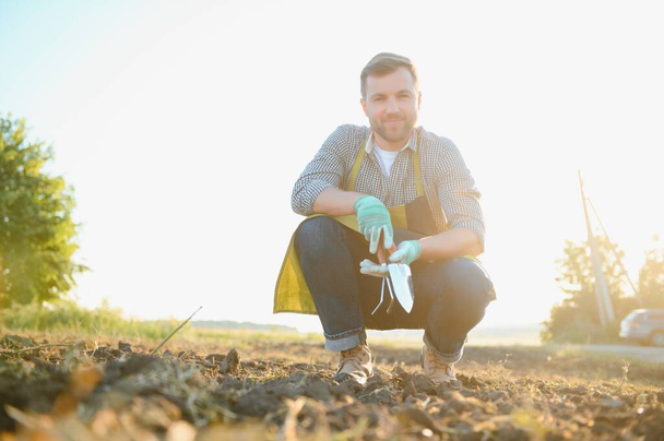 agriculture. farmer with a shovel in the field. business soil sun natural roducts harvest. - Fotoğraf, Görsel