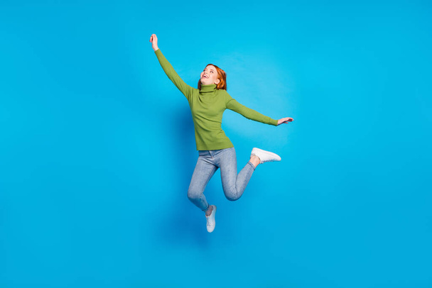 Full length body size view of pretty carefree dreamy cheerful girl jumping enjoying freedom isolated over bright blue color background. - Fotografie, Obrázek