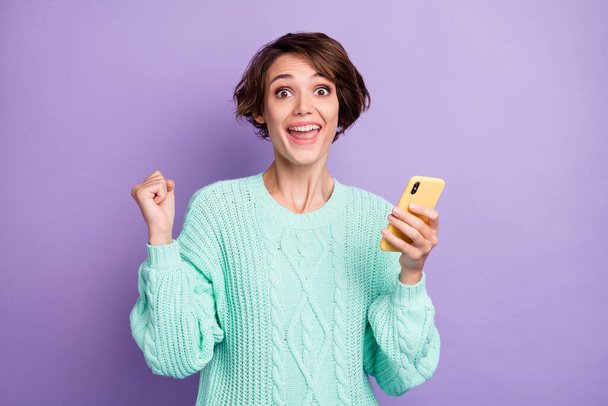 Portrait of attractive cheerful brown-haired girl using device fast speed 5g celebrating isolated over violet purple color background. - Foto, Imagen