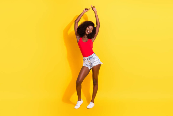 Full length body size view of attractive cheerful girl dancing having fun isolated over bright yellow color background. - Fotografie, Obrázek