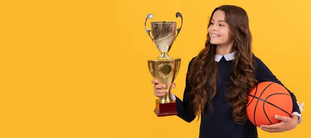 sport achievement award. teen girl with basketball ball and champion cup. Horizontal poster of isolated child face, banner header, copy space - Valokuva, kuva