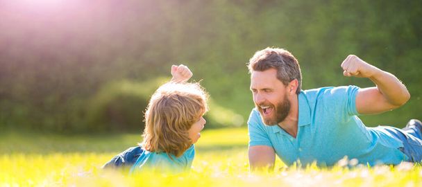 Banner of father and son in summer park outdoor. parent relax with little child boy on grass. glad dad with kid on summer day - Fotoğraf, Görsel