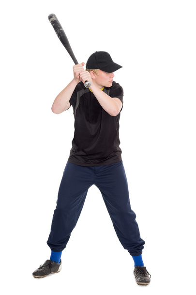 Young sportsman with a bat swings to strike - Фото, изображение