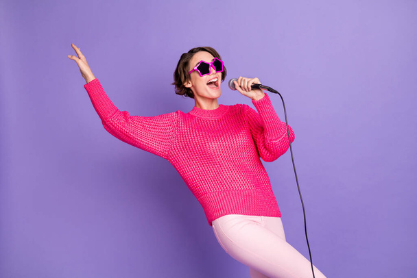 Photo of young crazy girl happy smile have fun sing pop music karaoke isolated over purple color background. - Foto, afbeelding