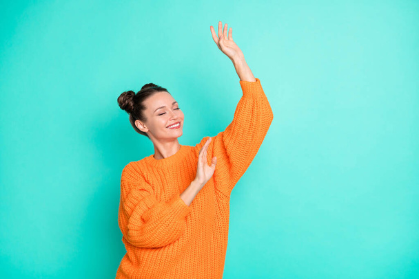 Photo of young attractive smiling good mood cheerful girl dancing wear knitted jumper isolated on turquoise color background. - Foto, immagini