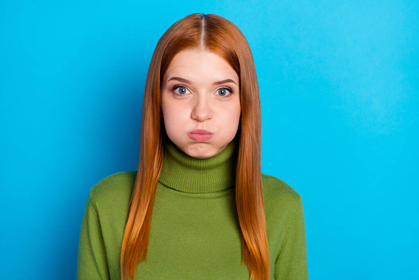 Photo of satisfied young person pouted cheeks holding breath look camera isolated on blue color background. - Fotoğraf, Görsel