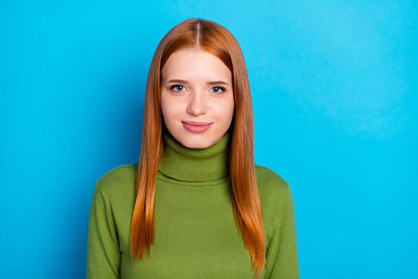 Portrait of attractive pretty shy red-haired girl isolated over bright blue color background. - Valokuva, kuva