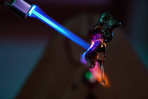 A close-up shot of caramelizing process of a green jelly bear - jelly bear on fire - 写真・画像
