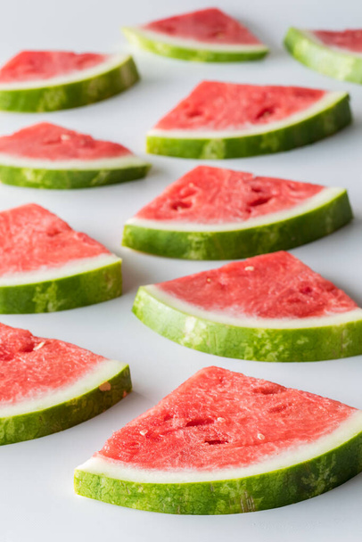 Several fresh juicy watermelon slices receding into the background.  - Zdjęcie, obraz
