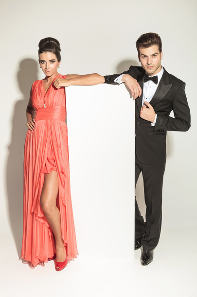 fashion couple leaning on a white empy board - Photo, Image