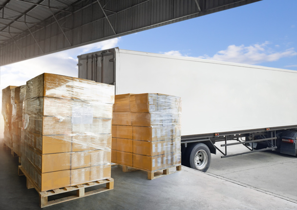 Packaging Boxes Wrapped Plastic Stacked on Pallets Loading into Cargo Container. Shipping Trucks. Supply Chain. Shipment Boxes. Distribution Supplies Warehouse. Freight Truck Transport Logistics. - Photo, Image