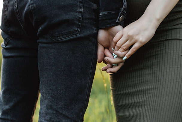 Horizontal close-up photo of a couple holding hands - Foto, Bild