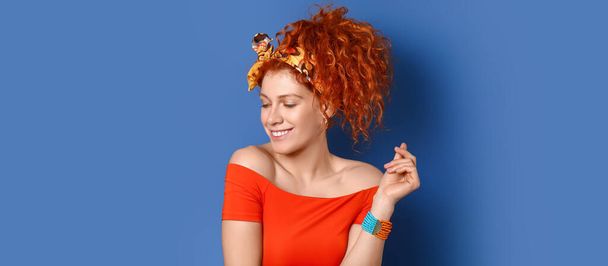 Gyönyörű vörös hajú nő kék háttér - Fotó, kép