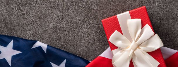 Concept of U.S Independence day or Memorial day. National flag over dark gray table background. - Photo, Image