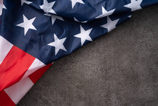 Concept of U.S Independence day or Memorial day. National flag over dark gray table background. - Foto, afbeelding