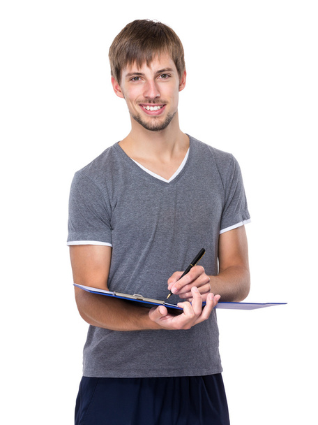 Young man with clipboard - Foto, imagen
