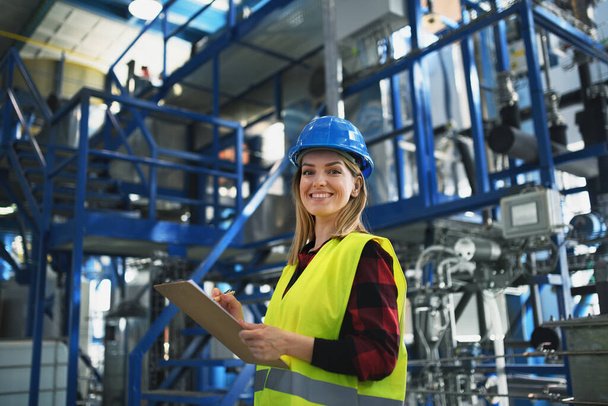 A portrait of female engineer working in industrial factory - Fotó, kép